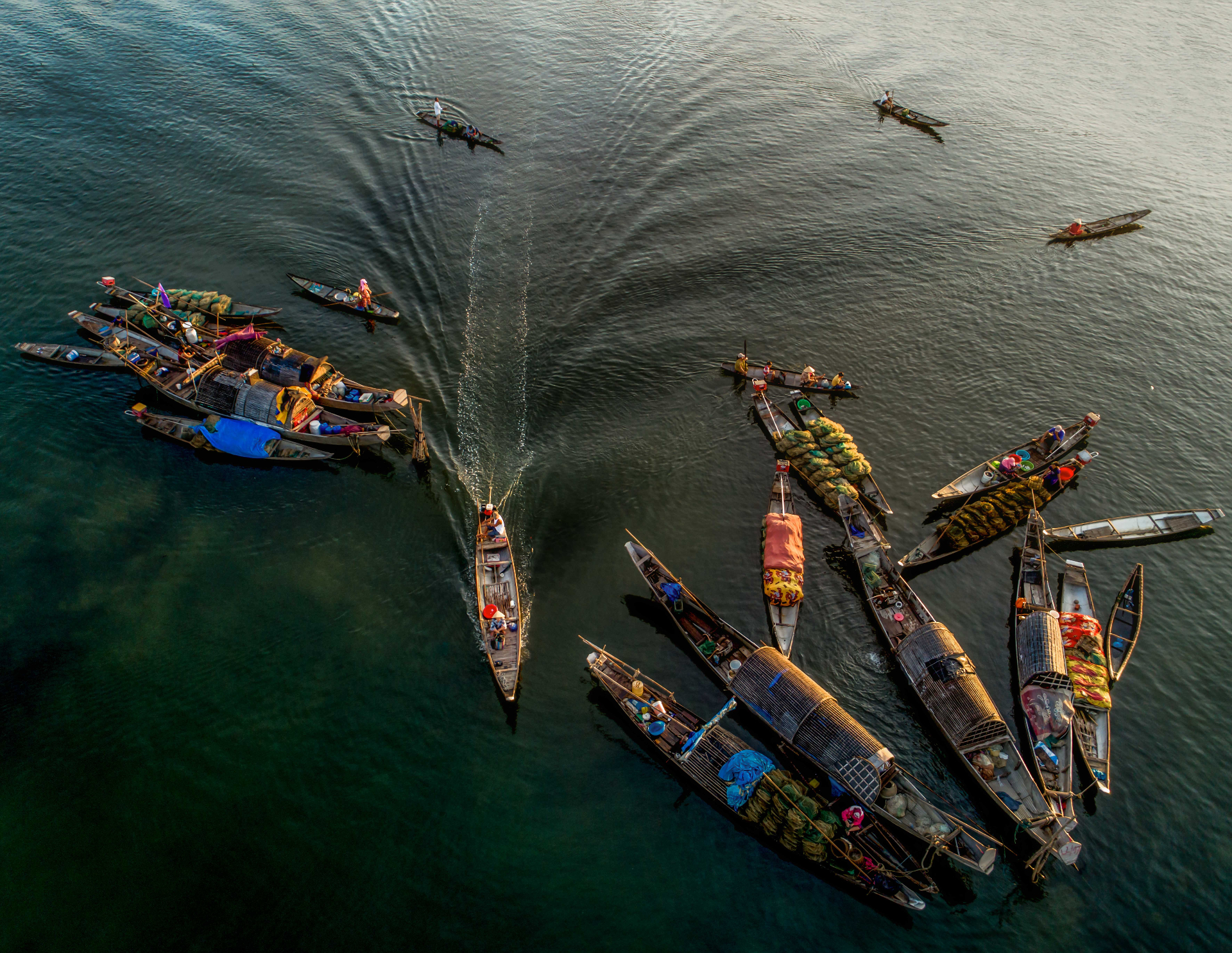 Aerial view of a boat on the Mekong River passing lush greenery